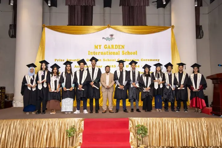 Students and teachers on stage at the graduation ceremony